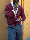 Burgundy V-neck button-front cardigan worn with gray trousers, exuding an elegant daily style.